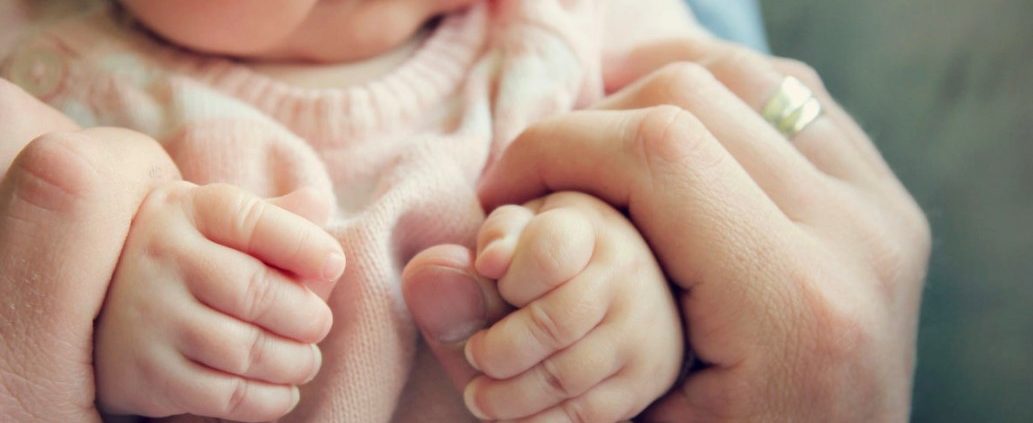 Baby in parent's hands